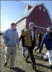 Sen. John Kerry, D-Mass., talks with retired farmers Richard, left,
and Mary C. Baumhover near Carroll, Iowa. Kerry, a candidate for
the Democratic presidential nomination, flew by helicopter to
several events Thursday in western Iowa.
