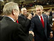 President Bush, right, greets Defense Secretary Donald Rumsfeld as
Secretary of State Colin Powell looks on prior to Bush's State of
the Union speech. In the nationally televised address Tuesday
night, Bush reminded Americans that the United States was still at
war and that the continued threat of terrorism was real.