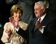 First lady Laura Bush, left, applauds Adnan Pachachi, president of
the Iraqi Governing Council, as President Bush recognizes him
during the State of the Union speech to a joint session of
Congress. The speech was Tuesday at the Capitol.