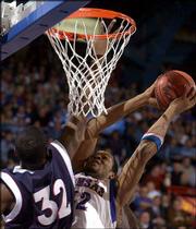 Kansas University's Jeff Graves, right, goes up for a shot against
Richmond's Jermaine Bucknor. The Jayhawks lost to the Spiders,
69-68, Thursday at Allen Fieldhouse.