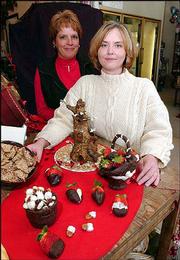 The Baldwin Community Arts Council will take bids on sweets, art
and services during its 16th annual Chocolate Auction Feb. 8. Among
the artists/bakers donating chocolate creations are Laura Morford,
left, who carved two chocolate baskets filled with chocolate-dipped
pecans and strawberries, and Karen Bayer, who spent 12 hours
sculpting a three-pound chocolate tree.