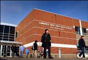 Students leave Free State High School at the end of a school day.
Under a 1992 law, the amount of money a district receives from the
state depends on how many students enroll, and one issue for
Lawrence officials is trying to estimate how many children will
show up for fall classes. Lawrence's enrollment has declined by 300
students in three years, to 9,600. Two-thirds of Kansas' school
districts are losing students.