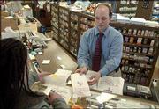 Tim Bredehoft, pharmacist at Medical Arts Pharmacy, 346 Maine,
gives a customer her medication. A Journal-World survey of Lawrence
pharmacies on Thursday revealed that prices of some popular drugs
can vary greatly, depending on where you shop.