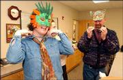 From left, Paula McMatton, Sidney Hardgrave and Tony Peterson try
on masks for Mardi Gras on the Kaw. The second annual fund-raiser
for Independence Inc. is scheduled for Valentine's Day and will
include cajun food, music, wine and, of course, beads and masks.