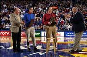 A new Hall of Athletics and a renovations to Allen Fieldhouse are
on tap at Kansas University with a $12 million gift from the Ward
family of Russell Stover Candies and a group of anonymous donors.
The gift was announced Saturday at halftime of the KU-Texas Tech
basketball game. Tom Ward (in red) is applauded by, from left, KU
associate athletic director John Hadl, K Club president Harry
Gibson and KU athletic director Lew Perkins.