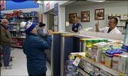 Wal-Mart pharmacist Larry Michels returns Gary Rumbaugh's thumbs-up
as Gary's mother, Dorothy Rumbaugh, rear center, leaves one of
Gary's prescriptions to be filled. Michels and his wife, Diane,
have a 17-month-old daughter, Faith, who, like Gary, has Down
syndrome.