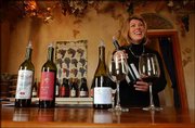 Jennifer Havens, proprietor of Wines, describes the characteristics
of one vintage offered for sampling in the tasting room at Wines by
Jennifer. The business is located in a restored home in Parkville,
Mo.