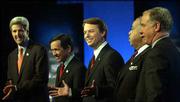 From left, John Kerry, Dennis Kucinich, John Edwards, Al Sharpton
and Howard Dean line up before a Democratic presidential candidate
debate at Marquette University in Milwaukee. During Sunday's
debate, the contenders targeted criticism at President Bush rather
than one another.