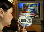 Kristen Connors, a toy demonstrator, becomes the fourth player in
Hasbro's Wheel of Fortune, competing against actual players on TV's
Wheel of Fortune game show. She played the game Feb. 13 in the
company's showroom at the American International Toy Fair in New
York. The game beams the puzzle from the TV directly to the
hand-held unit.