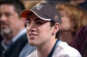 Former Kansas standout Nick Collison watches the Iowa State-KU game
from behind the Jayhawks' bench. Collison left the fieldhouse with
seven minutes left to catch a flight to Seattle.