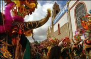 Devil dancers enter the Virgen del Socavon Church after doing a
pilgrimage during carnival celebrations in Oruro, Bolivia.
Thousands of dancers gathered Saturday in this mining city to pay
homage to the Virgen del Socavon while performing dances on their
pilgrimage to the virgin's chapel.