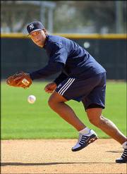New York's Alex Rodriguez fields a ground ball during practice. The
American League MVP -- who is making the switch from shortstop to
third base after being traded from Texas to the Yankees -- was
practicing Sunday at Tampa, Fla.