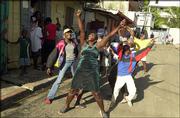 Haitians celebrate, some shouting "He's gone!," after news of
President Jean-Bertrand Aristide's departure reaches northern
Cap-Haitien, Haiti. Aristide on Sunday fled Haiti, bowing to
pressure from a rebellion at home and governments abroad, U.S. and
Haitian officials said.