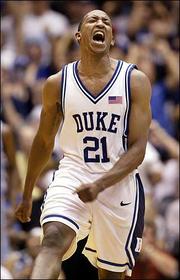Duke's Chris Duhon celebrates after scoring in the second half. The
Blue Devils beat North Carolina, 70-65, Saturday in Durham, N.C.