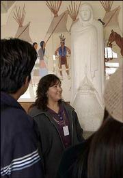 Lori Tapahonso, a spokeswoman at Haskell Indian Nations University,
talks with students about "Comrade in Mourning," a two-ton marble
sculpture by Allan Houser. The Haskell-commissioned sculpture,
created in the 1940s and on display in the university's auditorium,
will be part of the opening exhibit at the new National Museum of
the American Indian in Washington, D.C.