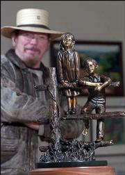 Lawrence sculptor Jim Brothers is the featured artist for the 2004
Lawrence Art Auction, set for April 24. Brothers is pictured with
"Promise," the bronze casting he donated for the auction.