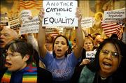 Demonstrators chant slogans in favor of same-sex marriage outside
the House Chamber at the Statehouse in Boston. Legislators on
Monday advanced a state constitutional ban on gay marriage that
would instead permit a civil union.
