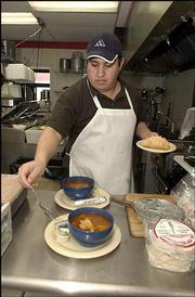 Angel Alvarez, co-owner of Tortas Jalisco, serves menudo, a
traditional, hearty Mexican dish made of beef stomach, hominy and
spices.