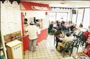 Angel Alvarez, co-owner of Tortas Jalisco, takes an order from a
customer at the restaurant, 3300 W. Sixth St. The Mexican
restaurant, which is located in a Phillips 66 gas station, was busy
during a recent lunch hour.