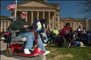 Brad Linnenkamp, Lawrence, a member of the Big Tent Coalition,
participates in the Rally for Freedom. Linnenkamp, who has cerebral
palsy, was dropped from a Medicaid waiver program in 2003 because
of state budget cuts.