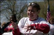 Kathy Lobb, Lawrence, representing the Self Advocates Coalition of
Kansas, applauds a speech by Gov. Kathleen Sebelius during the
annual Big Tent Coalition Rally for Freedom at the Statehouse in
Topeka. BTC is made up of more than 85 organizations that work to
ensure that Kansas seniors and people with disabilities get the
essential services they need. The rally was Wednesday in Topeka.