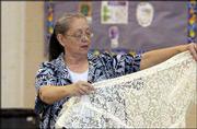 Donnis Graham, Lawrence, attends the East Lawrence Neighborhood
Assn. Yart Sale at New York School. The March 27 event was a
fund-raiser for the association's work day, block party and the
Hobbs Park mural project.