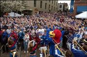 Kansas University fans "wave the wheat" during a pep rally in St.
Louis. Officials estimated about 3,000 fans attended Sunday's event
before the men's basketball game against Georgia Tech University in
the NCAA Tournament.