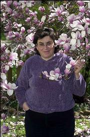 Lawrence poet Caryn Mirriam- Goldberg, shown here in front of a
magnolia tree, will read her work Friday at the Lawrence Arts
Center during the second installment of the 2004 Lawrence Poetry
Series. One of her recent poems is about magnolia trees.