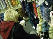 Genevieve Payne, of Lawrence, browses through racks of colorful
twisted yarn at the Yarn Barn, 930 Mass. More and more young women
-- and a few men -- are picking up the needles and learning to knit
and purl.