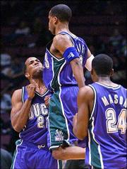 Milwaukee's Damon Jones celebrates with Michael Redd, left, and
Desmond Mason. Jones scored 23 points, and Redd scored 21 in the
Bucks' 103-98 victory Tuesday night in East Rutherford, N.J.