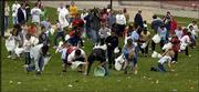Children scurry to gather candy-filled Easter eggs on Kansas
University's Campanile Hill. Members of Sigma Alpha Epsilon
fraternity and Delta Delta Delta sorority organized Friday's event
for hundreds of Lawrence children.