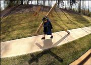Nate Hughes, 7, Hoschton Ga., carries a wooden cross that he made
with his father. For the third year in a row, Nate, who weighs 40
pounds, carried the 45-pound cross through his neighborhood on Good
Friday morning. Nate said he started the ritual at age 5 because he
wanted to remind people of Jesus' sacrifice for them.