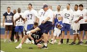 Former Kansas football coach Don Fambrough kicks an extra point in
a tie game with no time remaining. The kick was blocked, but later
ruled good because of a rules violation, awarding the Blue team a
14-13 alumni-game victory Sunday at KU's Memorial Stadium.