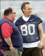 Kansas coach Mark Mangino, left, and former Jayhawk Jim Fender
chat. Fender caught both touchdown passes for the Blue team in its
14-13 victory in the alumni game Sunday at Memorial Stadium.