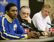 Indiana forward Ron Artest, left, listens to a question during a
news conference as Pacers CEO Donnie Walsh, center, and Larry Bird
look on. Artest spoke Monday in Indianapolis about being suspended
for Game 2 against Boston and being chosen the NBA's Defensive
Player of the Year.