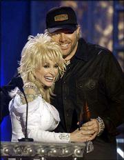Toby Keith gets a hug from host Dolly Parton as Keith is awarded
the video of the year at the Flame Worthy Awards show in Nashville,
Tenn. The Flame Worthy Awards are given to country music videos.
Keith won Wednesday for his video "American Soldier," and took home
two other awards.