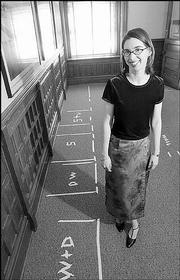 Rebecca Phipps, director of Watkins Community Museum of History, is
proposing a kitchen project for the museum to accommodate groups
looking to rent the lower-level community room. Phipps has taped
out a kitchen layout in the proposed area.