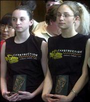 Paula Kyriakos and Michelle Jones, both members of Girl Scout Troop
623, hold the trophies that their group won during a Canstruction
fund-raising project. The troop and Sabatini & Associates
Architects won trophies for structural ingenuity and honorable
mention. They designed a Snoopy doghouse from canned goods. The
project represented the troop's volunteer work with the Lawrence
Humane Society. The event, which raised money for area youth groups
and helped fill local food pantries, was Saturday at CornerBank in
Lawrence.