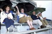 Kansas University alumni and football fans, from left, are Pat
Herrin, Stella Dyer, Kermit Dyer and Keith Herrin. The Lawrence
residents attended the KU spring football game Sunday at Memorial
Stadium. A few sprinkles didn't keep these Jayhawk fans from
getting an early0 glimpse of the football team.