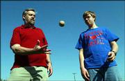 Bill James, left, and his son Isaac, 15, play catch at Hobbs Park.
James and wife Susan have three children -- Rachel, 17, Isaac and
Reuben, 10.