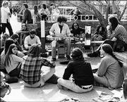 Roger Shimomura, the bespectacled man crouched to the right of the
guitar player, hangs out with Kansas University students on campus.
The photo was taken in 1970, one year after Shimomura joined the KU
art faculty.