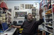 Roger Shimomura works in his home office, which is packed with
books, binders full of slides of his artwork, family photographs
and collectibles. Shimomura spends hours at his computer and can
often be found surfing eBay, a Web site that feeds his former
auction-going habit.