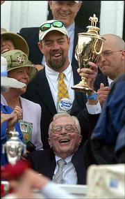Roy Chapman, owner of Smarty Jones, lifts the trophy in celebration
of his his win of the 130th running of the Kentucky Derby. The
77-year-old Chapman was a surprise winner at Saturday's Derby in
Louisville, Ky.