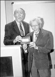 Dr. Doug Witt, left, and Dr. Henry Remple accept the Pioneer Award
on behalf of recipient Dr. Sandra Shaw, who was unable to attend
the Bert Nash Community Mental Health Center's Pioneer Celebration.
The event was April 20. Witt is a former Bert Nash clinical
director, and Remple is a former board member.