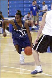 Rocktown's Marcus Walker makes a move against New Mexico. Walker
led his team to victory Saturday at Allen Fieldhouse.
