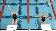 Free State High's Kelsi Mishler, left, and Lawrence High's Melissa
Farve start the 100-yard backstroke consolation heat at the
Sunflower League swimming championships. The meet was Saturday at
the Lawrence Indoor Aquatic Center.