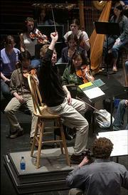 Nicholas Uljanov, director of orchestral activities at Kansas
University, rehearses with the KU Symphony Orchestra at the Lied
Center. The group prepared last week for their spring concert,
which is at 3 p.m. today. Uljanov is completing his first year as
director.