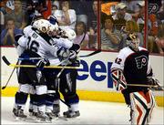 Tampa Bay Lightning players celebrate a goal by Brad Richards in
the third period as Philadelphia goalie Robert Esche skates away.
The Lightning won Game 3 of the Eastern Conference finals, 4-1,
Thursday in Philadelphia to take a 2-1 lead in the series.