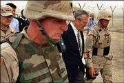 U.S. Defense Secretary Donald Rumsfeld, center, tours the prison of
Abu Ghraib with Maj. Gen. Geoffrey Miller, right, commander of the
prison system in Iraq, shortly after his arrival in Baghdad.
Rumsfeld said Thursday "the abuses of a few" would not change
prison policies.