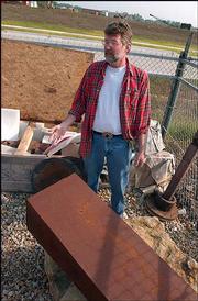 Lawrence arts commissioner Jeff Ridgway looks over abandoned and
donated artworks from past Outdoor Downtown Sculpture Exhibitions.
Ridgway recently found a sculpture broken, prompting him to demand
the city find more suitable storage for the pieces.